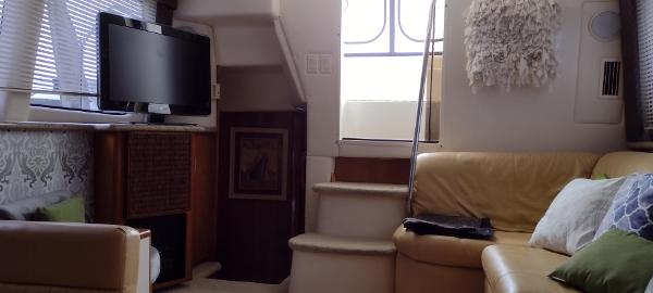 Slide: The Image of Interior of 2002 Carver 356 Motor Yacht with cozy seating and TV. - 27