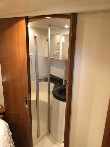 Slide: The Image of 2004 Carver 366 Motor Yacht bathroom with wooden door and glass shower enclosure. - 10