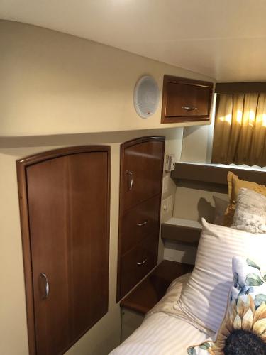 Slide: The Image of Interior cabin of 2004 Carver 366 Motor Yacht with wooden cabinets and cozy bedding. - 12