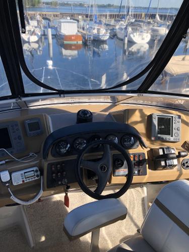 Slide: The Image of 2004 Carver 366 Motor Yacht helm with navigation equipment and marina view. - 17