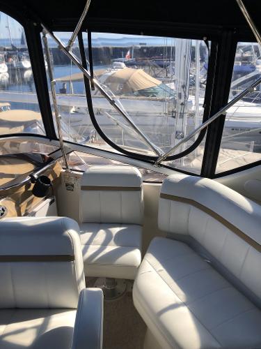 Slide: The Image of Interior of a 2004 Carver 366 Motor Yacht with white leather seating. - 19
