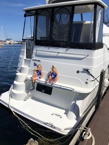 Slide: The Image of 2004 Carver 366 Motor Yacht docked with two children sitting on the stern. - 3