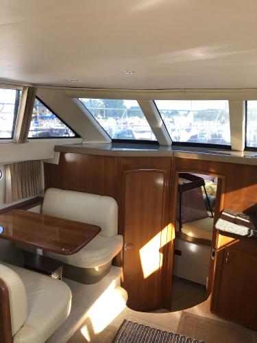 Slide: The Image of Interior of a 2004 Carver 366 Motor Yacht with dining area and windows. - 6