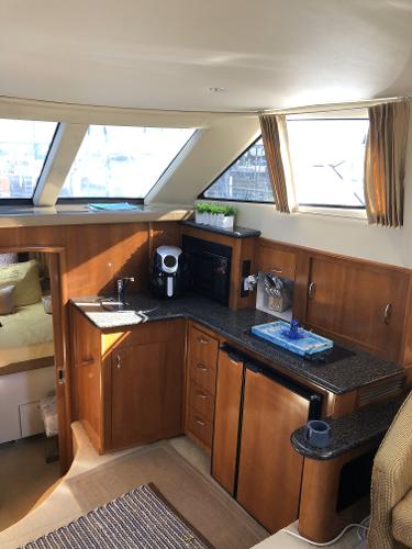 Slide: The Image of Interior of 2004 Carver 366 Motor Yacht with modern kitchen amenities. - 7