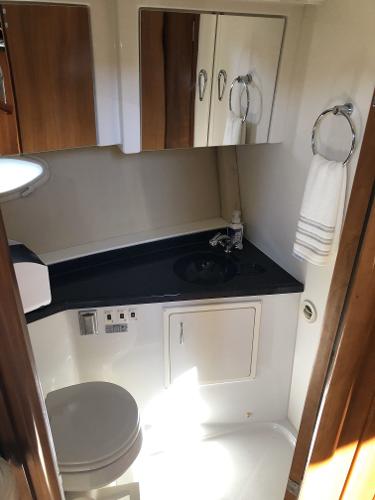 Slide: The Image of Bathroom interior of a 2004 Carver 366 Motor Yacht with sink, toilet, and storage cabinets. - 8