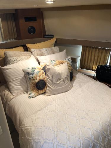 Slide: The Image of Cozy bedroom in a 2004 Carver 366 Motor Yacht with sunflower-themed pillows. - 9