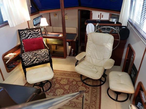 Slide: The Image of Interior of 1986 Carver 36 Aft Cabin with cozy seating and nautical decor. - 10