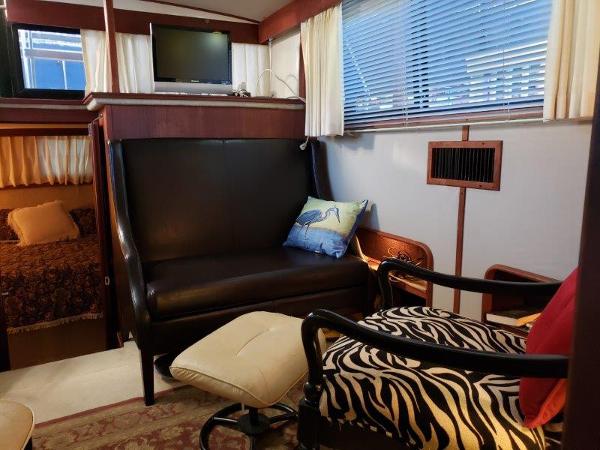 Slide: The Image of Interior of 1986 Carver 36 Aft Cabin with cozy seating and decor. - 11