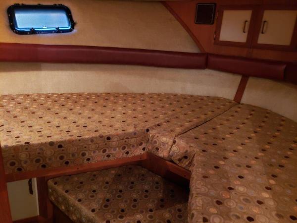 Slide: The Image of 1986 Carver 36 Aft Cabin interior with patterned bedding and porthole window. - 15