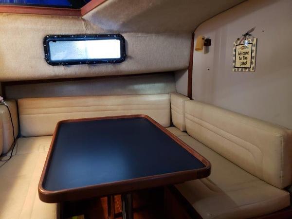 Slide: The Image of 1986 Carver 36 Aft Cabin interior with dining area and window. - 16