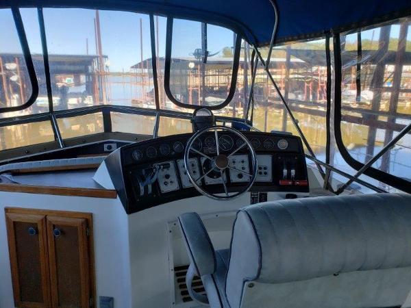 Slide: The Image of Interior helm of 1986 Carver 36 Aft Cabin yacht, featuring steering wheel and control panel. - 7