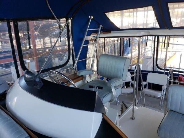 Slide: The Image of 1986 Carver 36 Aft Cabin interior with helm, seating, and windows. - 8