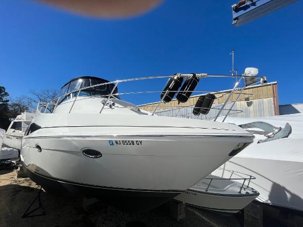 Slide: The Image of 2006 Carver 36 Mariner boat docked on land under clear blue sky. - 0