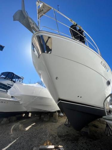 Slide: The Image of 2006 Carver 36 Mariner yacht on dry dock under clear blue sky. - 1