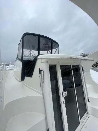 Slide: The Image of 2006 Carver 36 Mariner yacht with enclosed flybridge and sliding glass doors. - 13