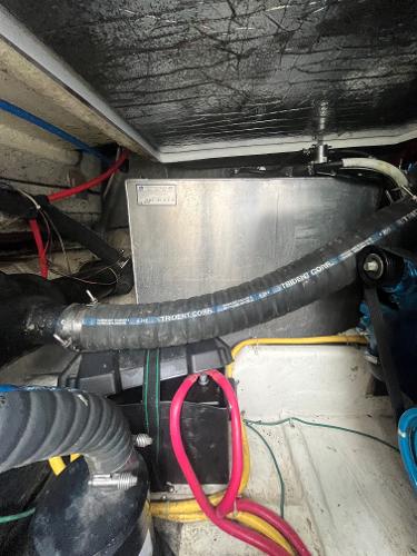 Slide: The Image of Engine compartment of a 2006 Carver 36 Mariner boat with various hoses and wiring. - 18