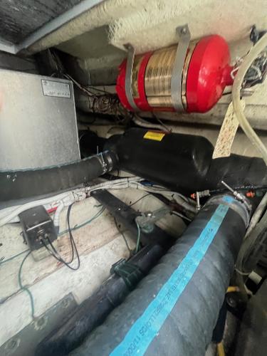 Slide: The Image of Engine compartment of a 2006 Carver 36 Mariner boat with hoses and equipment. - 20