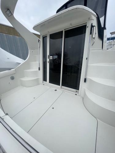 Slide: The Image of 2006 Carver 36 Mariner yacht with sliding glass doors and curved steps. - 27