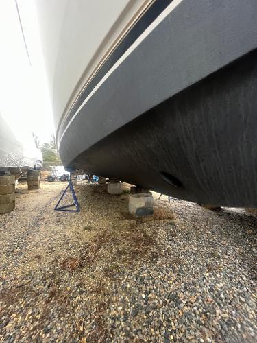 Slide: The Image of 2006 Carver 36 Mariner boat hull on dry dock, supported by blocks and stands. - 31