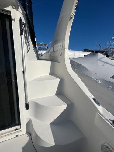 Slide: The Image of Staircase on a 2006 Carver 36 Mariner yacht under clear blue sky. - 32
