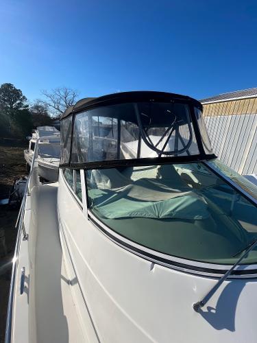 Slide: The Image of 2006 Carver 36 Mariner boat with black canopy and clear windows. - 39