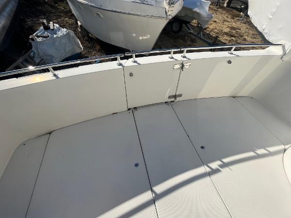 Slide: The Image of 2006 Carver 36 Mariner boat deck with white railing and clean surface. - 48