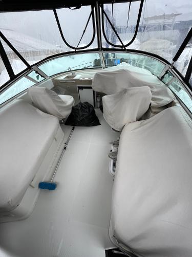 Slide: The Image of 2006 Carver 36 Mariner boat interior with covered seating and helm. - 5