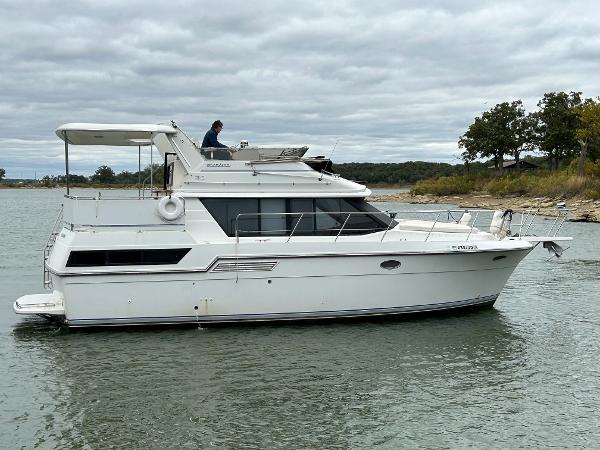 Slide: The Image of 1992 Carver 38 Aft Cabin yacht on calm water, overcast sky. - 1