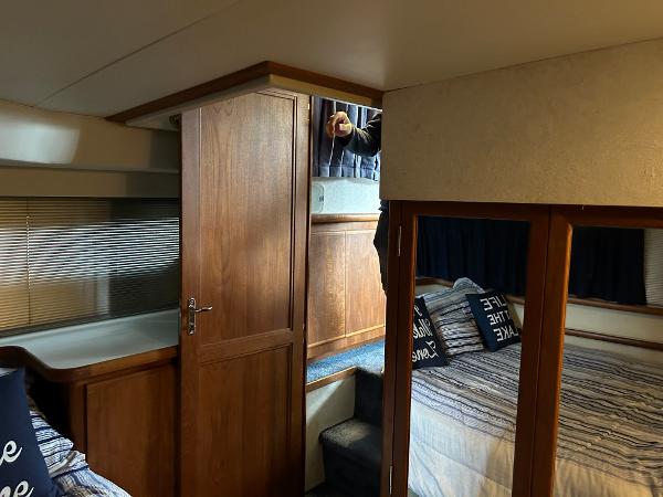 Slide: The Image of Interior of 1992 Carver 38 Aft Cabin with wood paneling and cozy bedding. - 10