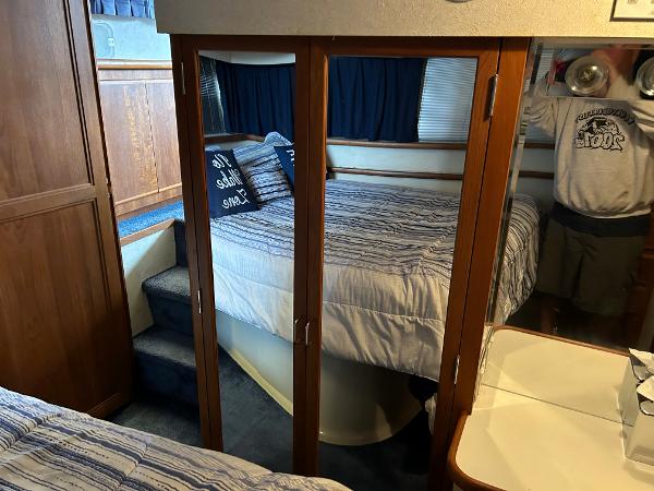 Slide: The Image of 1992 Carver 38 Aft Cabin interior with mirrored closet and cozy bed. - 12