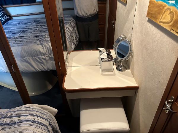 Slide: The Image of 1992 Carver 38 Aft Cabin interior with vanity, mirror, and bed. - 13