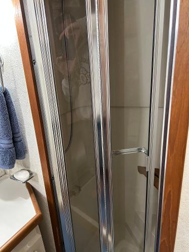 Slide: The Image of Shower area in 1992 Carver 38 Aft Cabin yacht with glass door and towel rack. - 14
