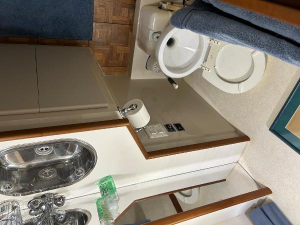Slide: The Image of Bathroom interior of 1992 Carver 38 Aft Cabin yacht, featuring sink and toilet. - 15