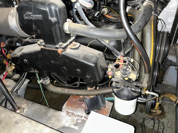 Slide: The Image of Engine compartment of a 1992 Carver 38 Aft Cabin boat, showing mechanical components and wiring. - 20