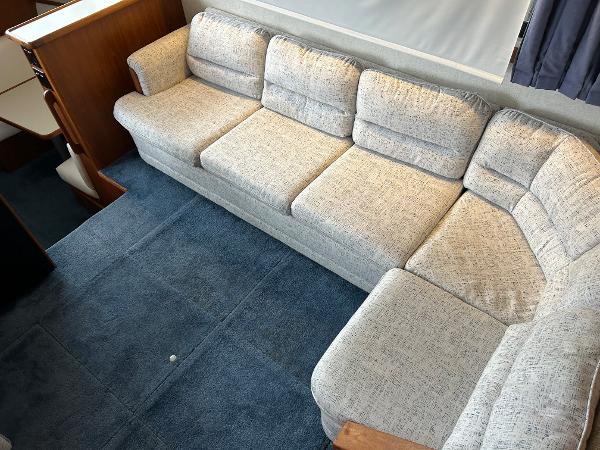 Slide: The Image of Spacious interior of 1992 Carver 38 Aft Cabin with plush beige sofa and blue carpet. - 26