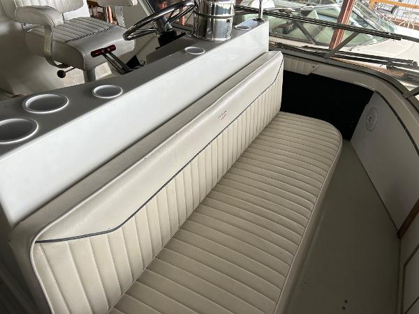Slide: The Image of 1992 Carver 38 Aft Cabin interior with white seating and helm station. - 27