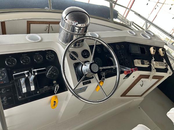 Slide: The Image of 1992 Carver 38 Aft Cabin helm with steering wheel, controls, and navigation instruments. - 29