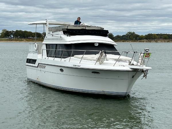 Slide: The Image of 1992 Carver 38 Aft Cabin yacht on water, for sale sign visible. - 3