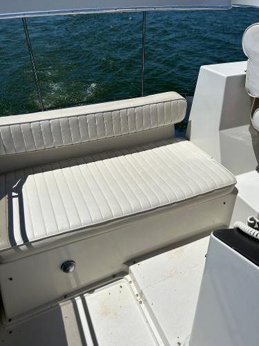 Slide: The Image of 1992 Carver 38 Aft Cabin boat with white cushioned seating, overlooking water. - 30