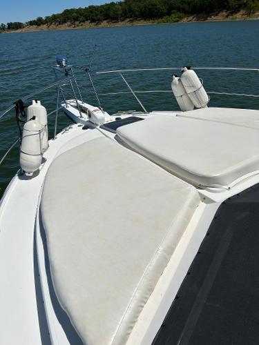 Slide: The Image of 1992 Carver 38 Aft Cabin boat with sun pads on deck, floating on a lake. - 32