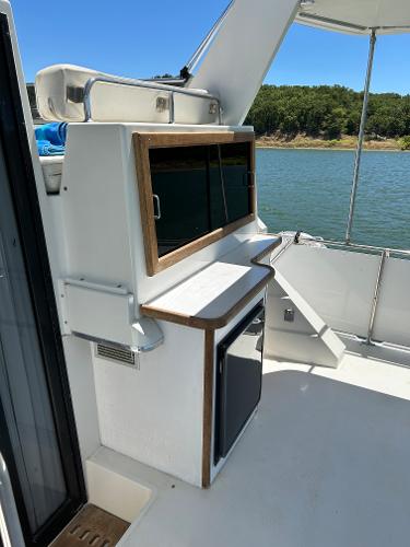 Slide: The Image of 1992 Carver 38 Aft Cabin yacht interior with cabinetry and water view. - 33