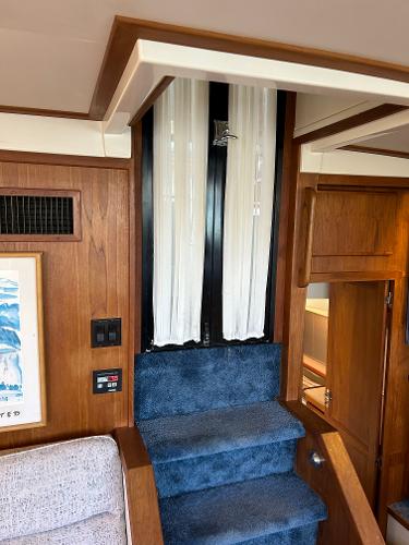 Slide: The Image of Interior of 1992 Carver 38 Aft Cabin with blue carpeted stairs and wood paneling. - 35