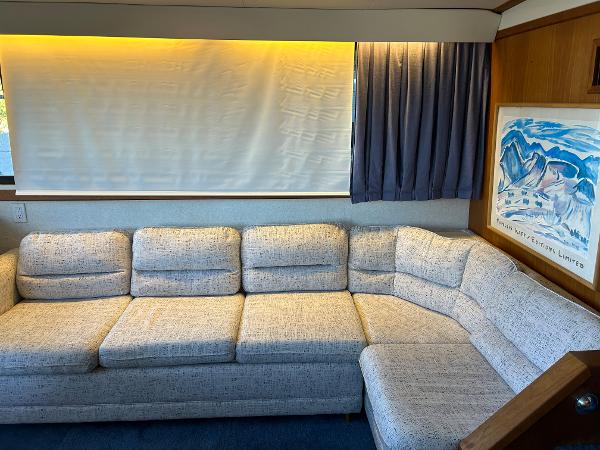 Slide: The Image of 1992 Carver 38 Aft Cabin interior with L-shaped sofa, curtains, and wall art. - 36