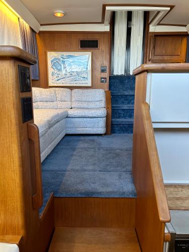 Slide: The Image of Interior of 1992 Carver 38 Aft Cabin with cozy seating and wooden accents. - 37