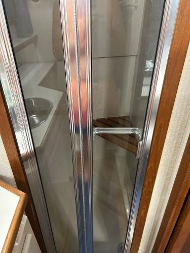 Slide: The Image of Shower area in 1992 Carver 38 Aft Cabin yacht with glass door and wooden accents. - 43
