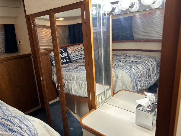 Slide: The Image of 1992 Carver 38 Aft Cabin interior with cozy bedroom and mirrored vanity area. - 44
