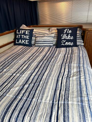 Slide: The Image of Cozy cabin bedroom in 1992 Carver 38 Aft, nautical-themed bedding and pillows. - 45