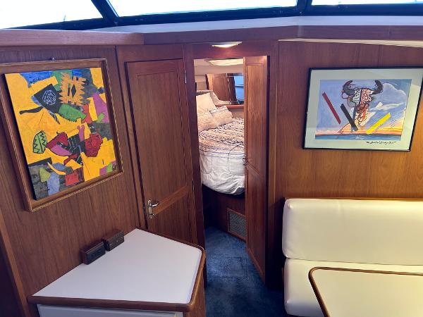 Slide: The Image of Interior of 1992 Carver 38 Aft Cabin with colorful artwork and cozy bedroom. - 47