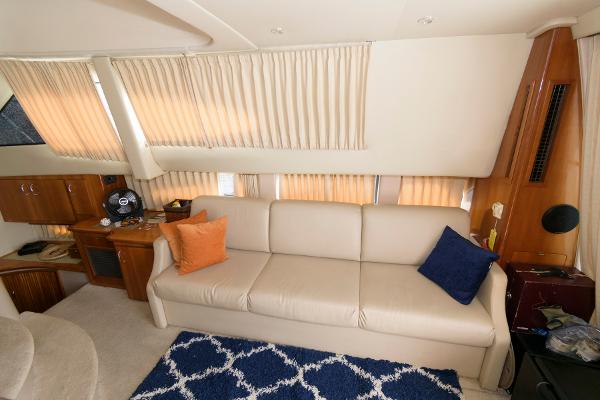 Slide: The Image of Interior of 2006 Carver 38 Super Sport yacht with beige sofa and blue rug. - 13