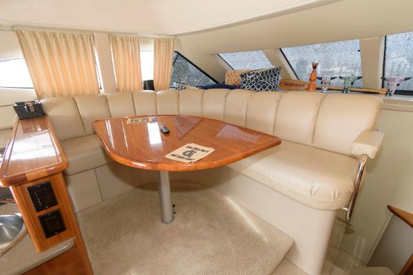 Slide: The Image of Luxurious interior of 2006 Carver 38 Super Sport yacht with leather seating and wooden table. - 15